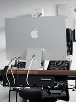 A tech influencer showcasing a sleek AI gadget in a modern UAE office setting.