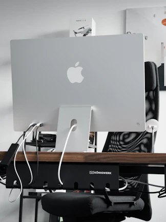 Hands unboxing a new tech gadget on a clean desk with minimalist decor