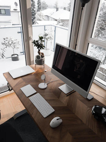 a desk with a computer, keyboard and mouse