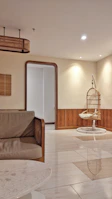 A cozy, stylish home interior featuring deep beige walls and black accents.