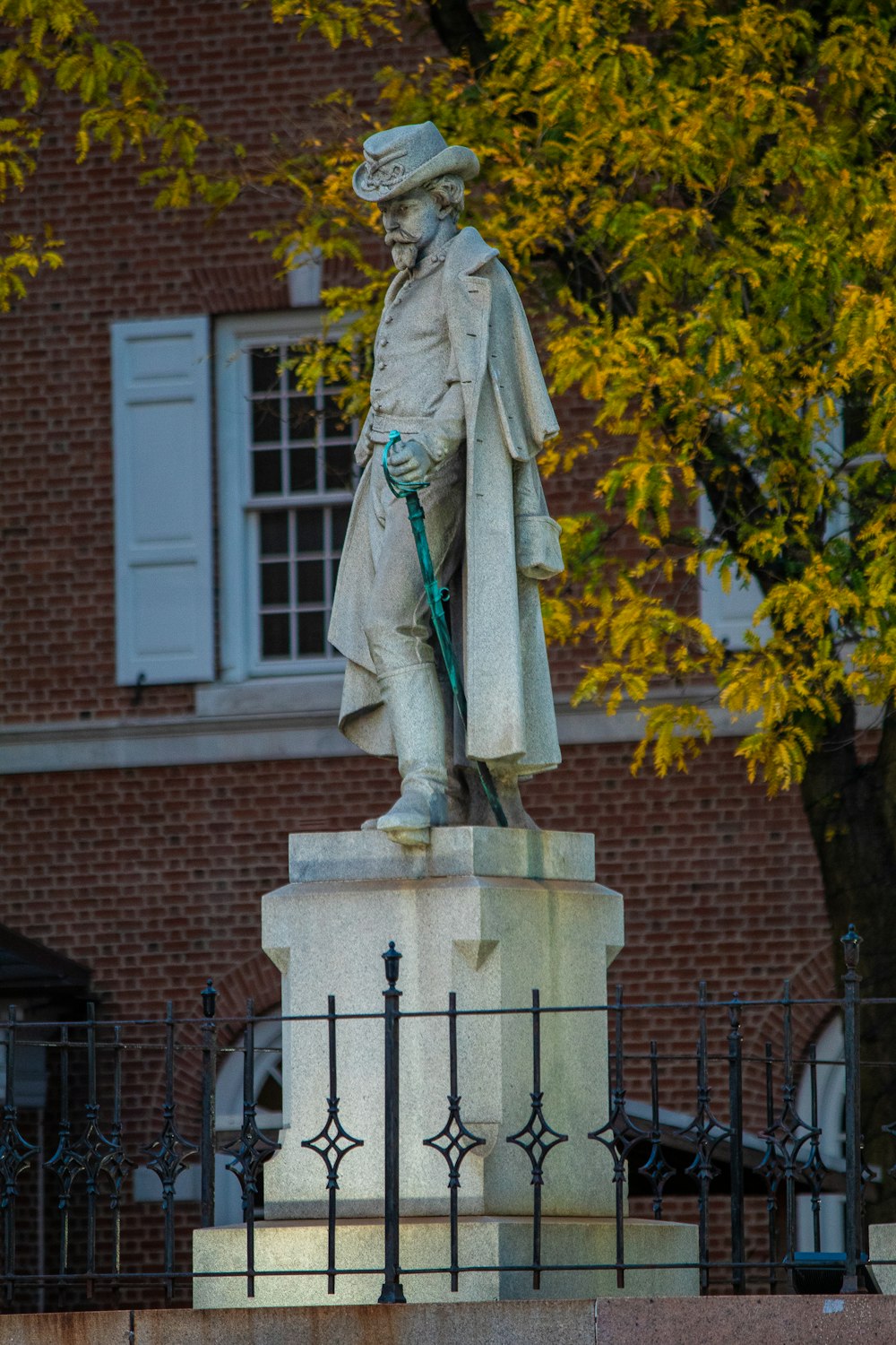 a statue of a man with a hat and cane