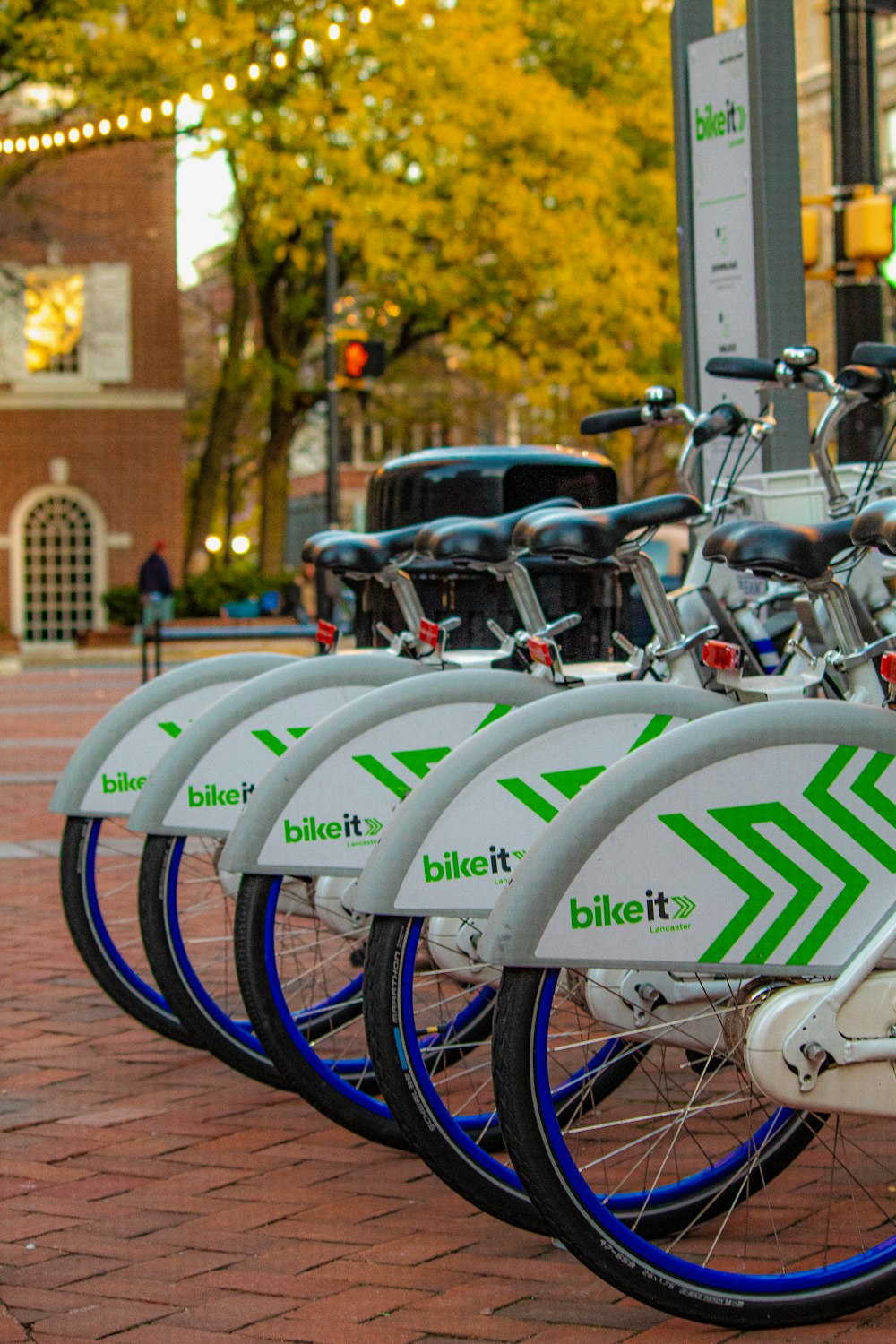 a row of bikes parked next to each other on a sidewalk