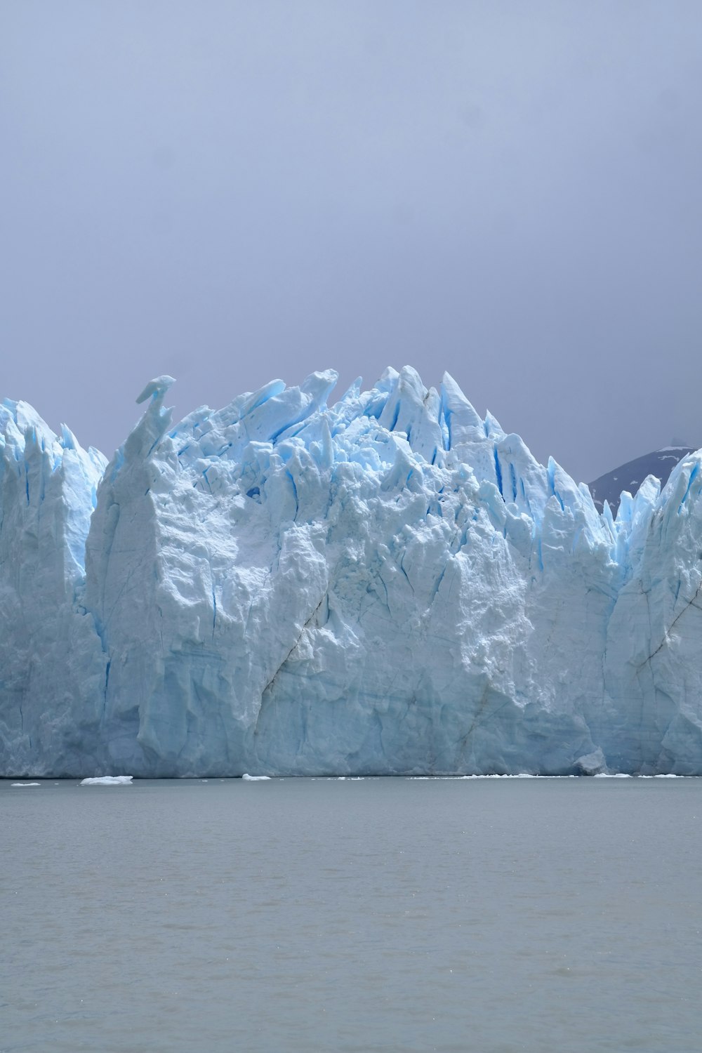 a large iceberg in the middle of a body of water