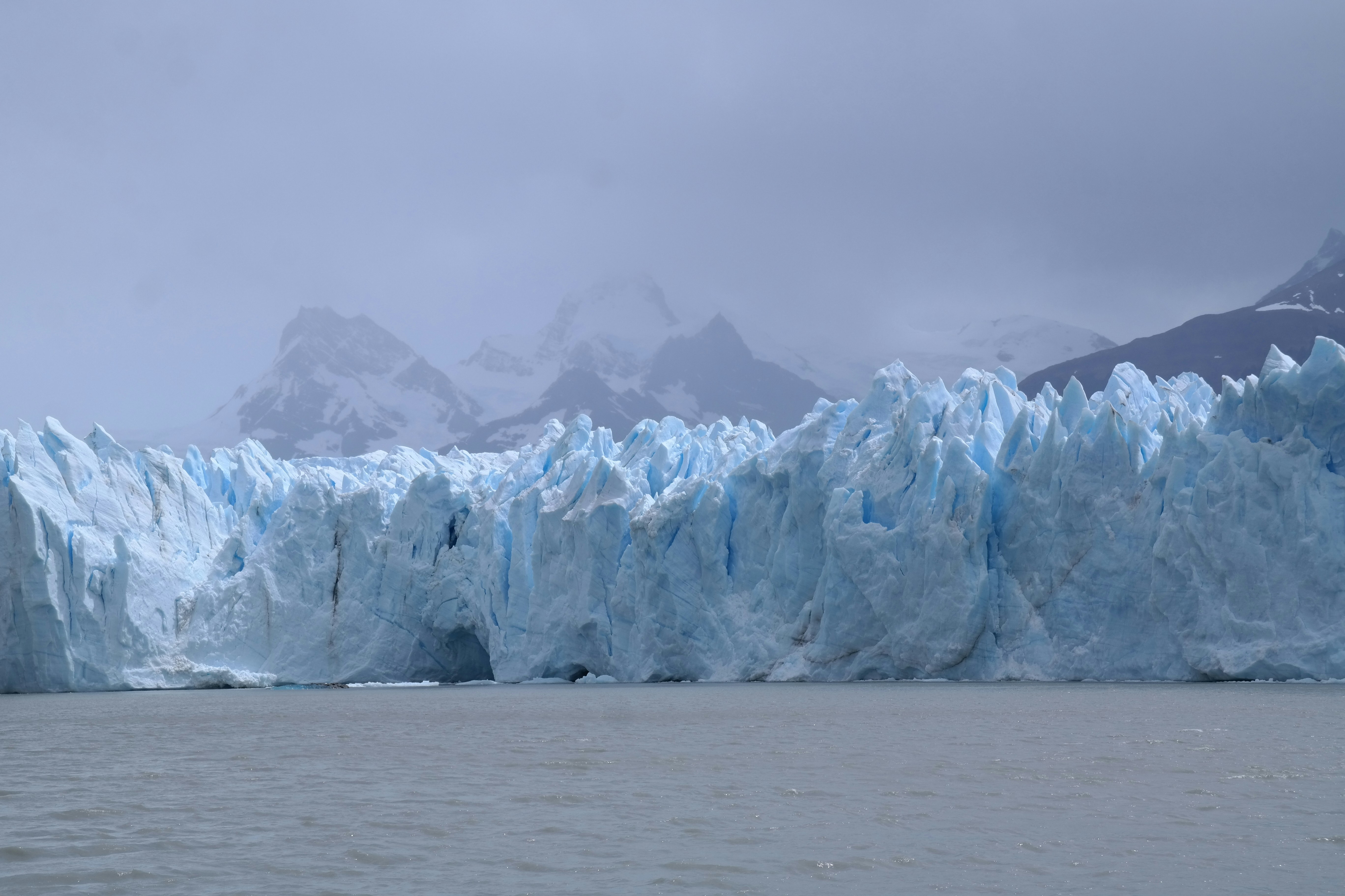 a large glacier wall in the middle of a body of water