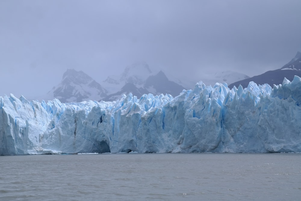 a large glacier wall in the middle of a body of water