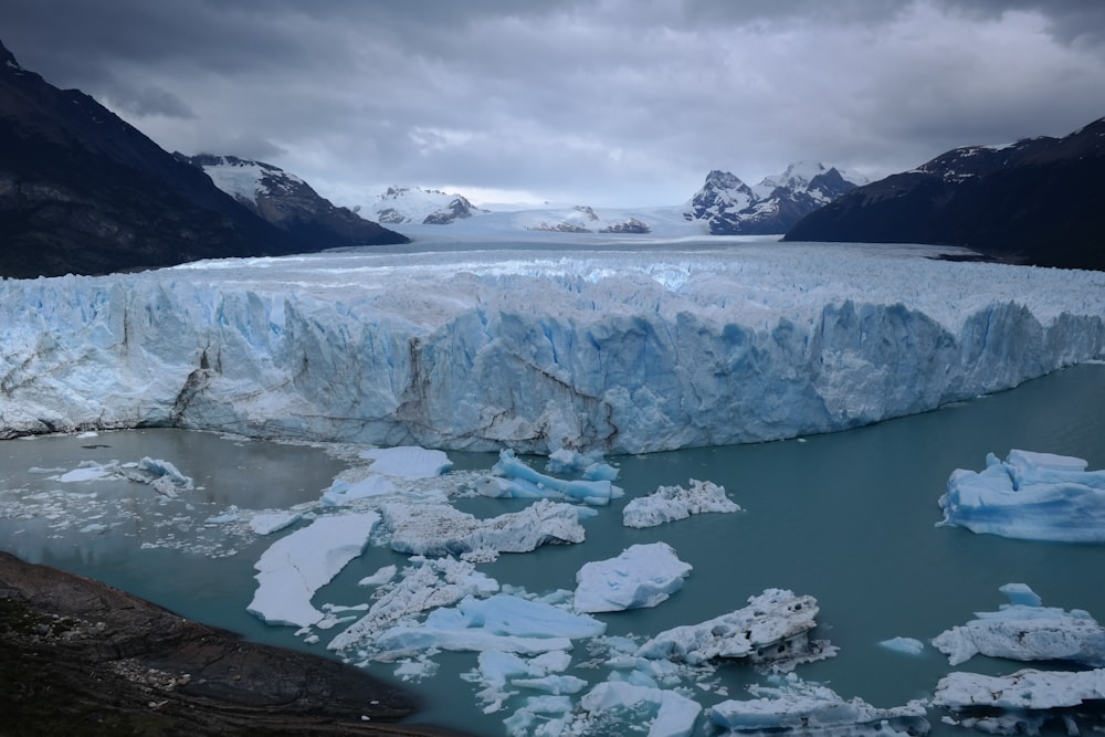 a large iceberg in the middle of a body of water