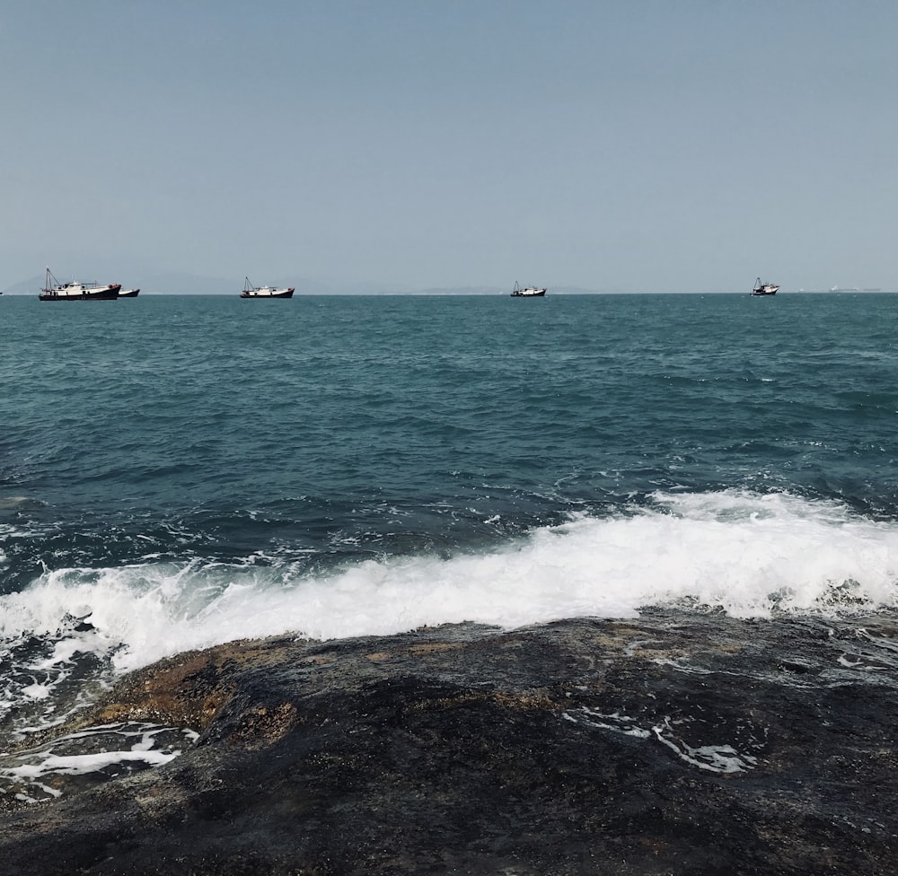 a group of boats floating on top of a large body of water