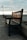 a wooden bench sitting next to the ocean