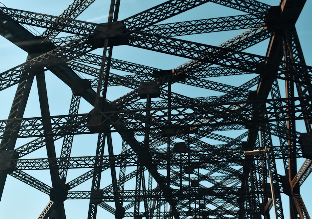 a close up of a metal structure with a blue sky in the background