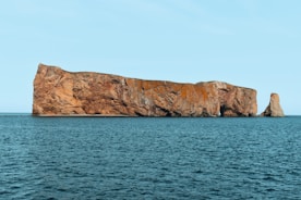 a large rock in the middle of the ocean