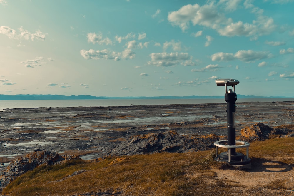 a telescope on top of a stand in the middle of a field