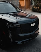 a black suv parked in front of a building
