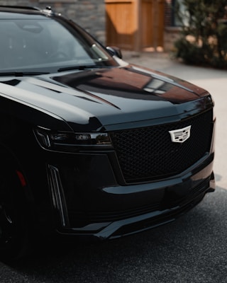 a black suv parked in front of a building