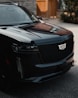 a black suv parked in front of a building