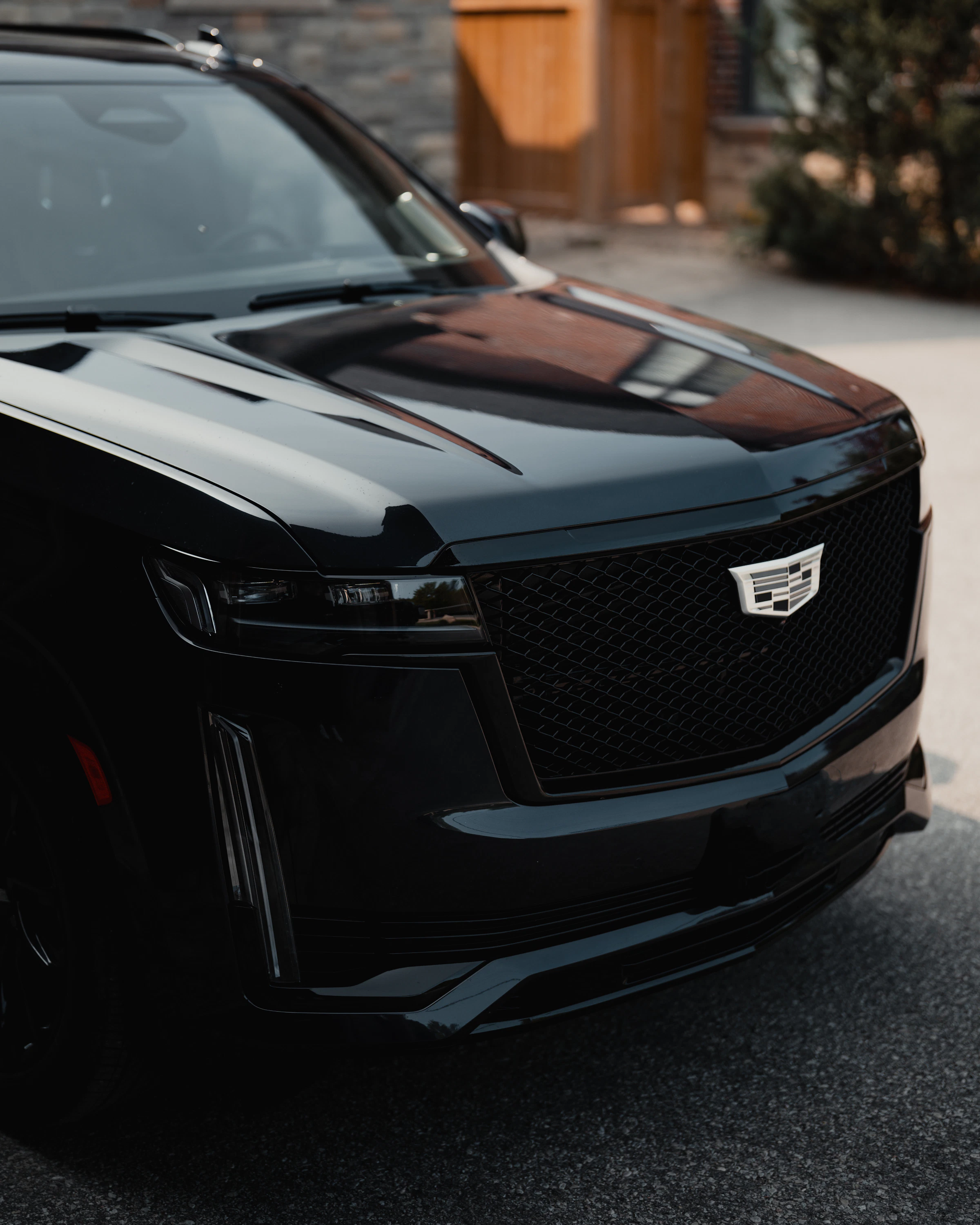 Blacked-out luxury SUV with a deep reflective finish in dramatic light