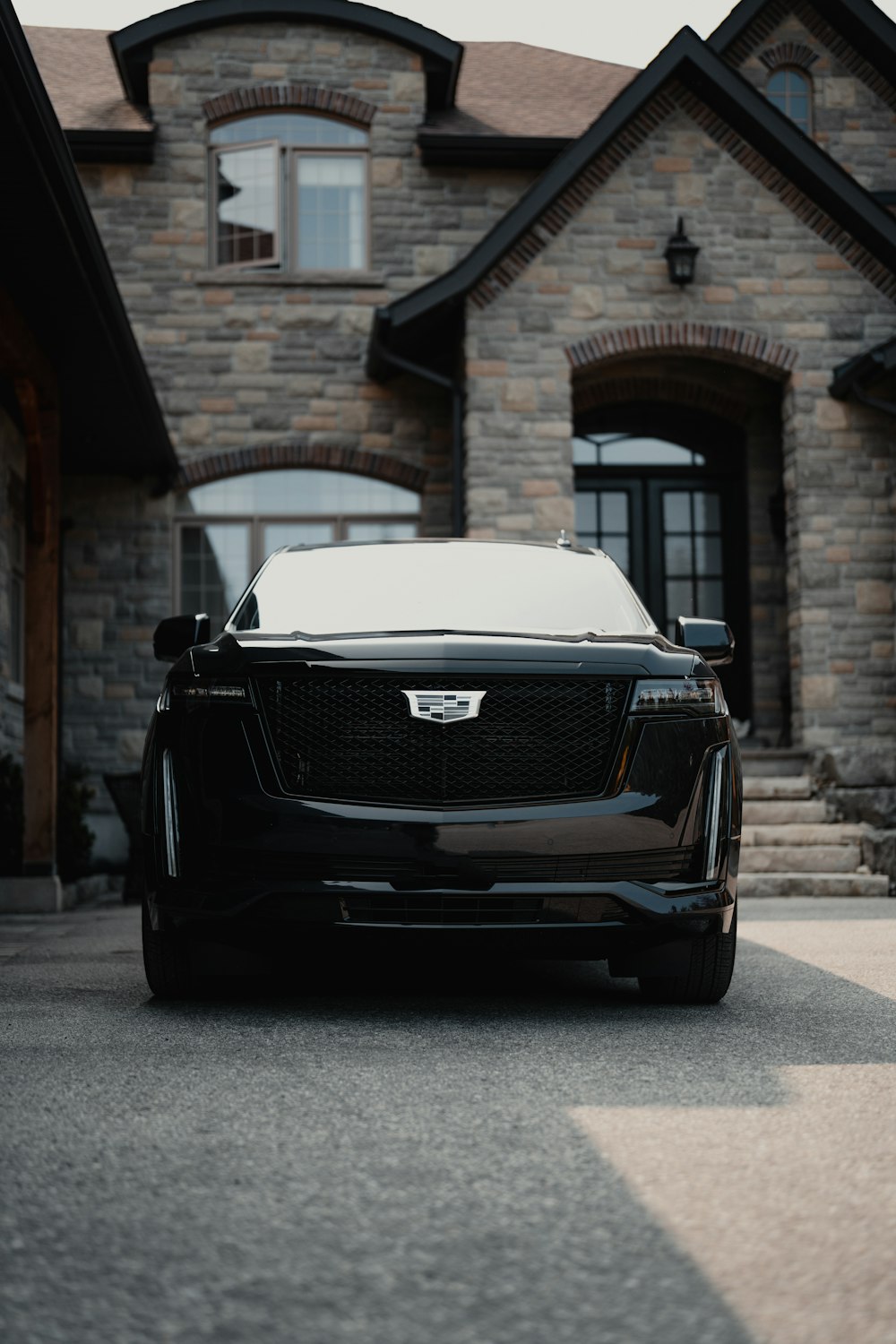 a black car parked in front of a house