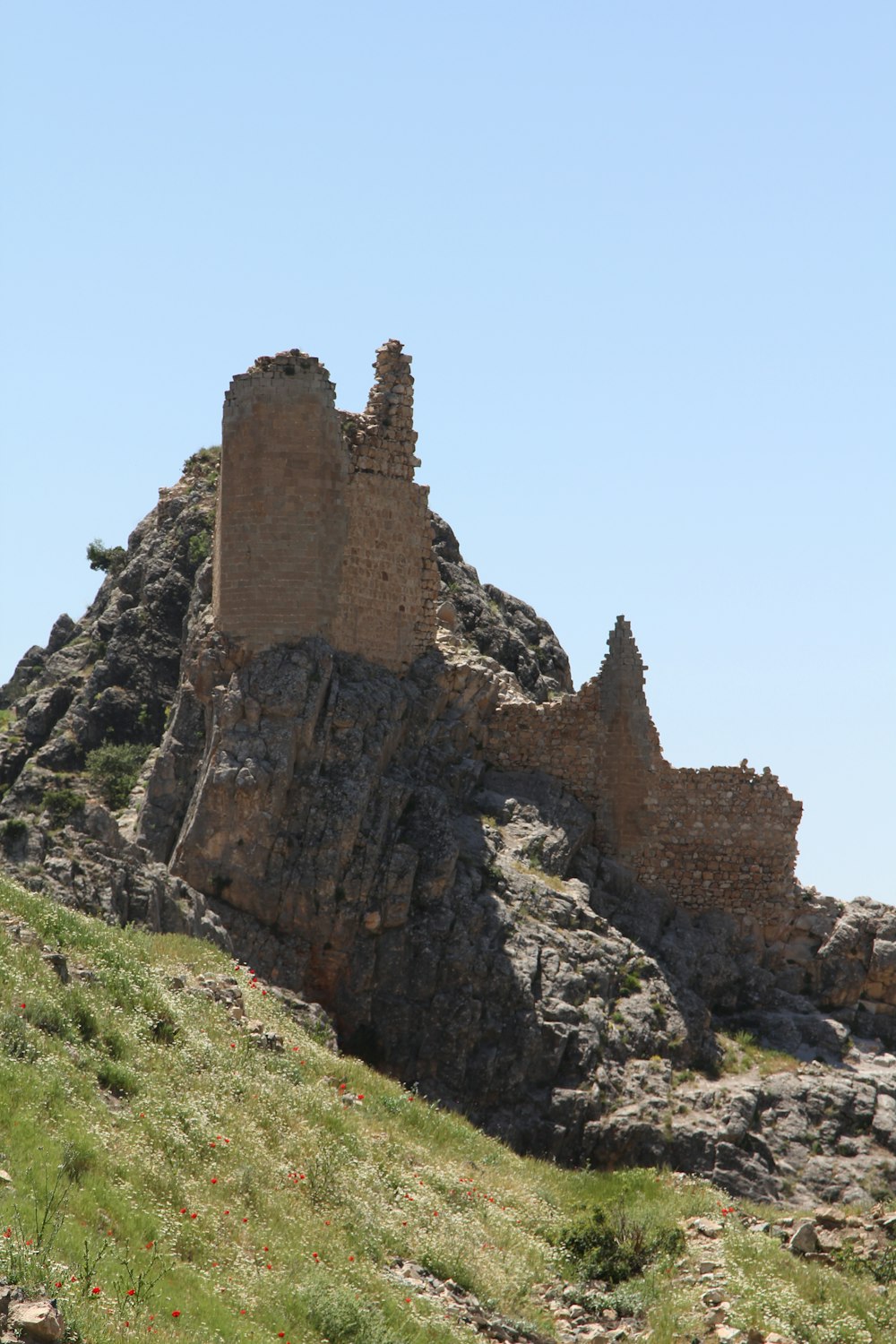 an old castle on top of a rocky hill