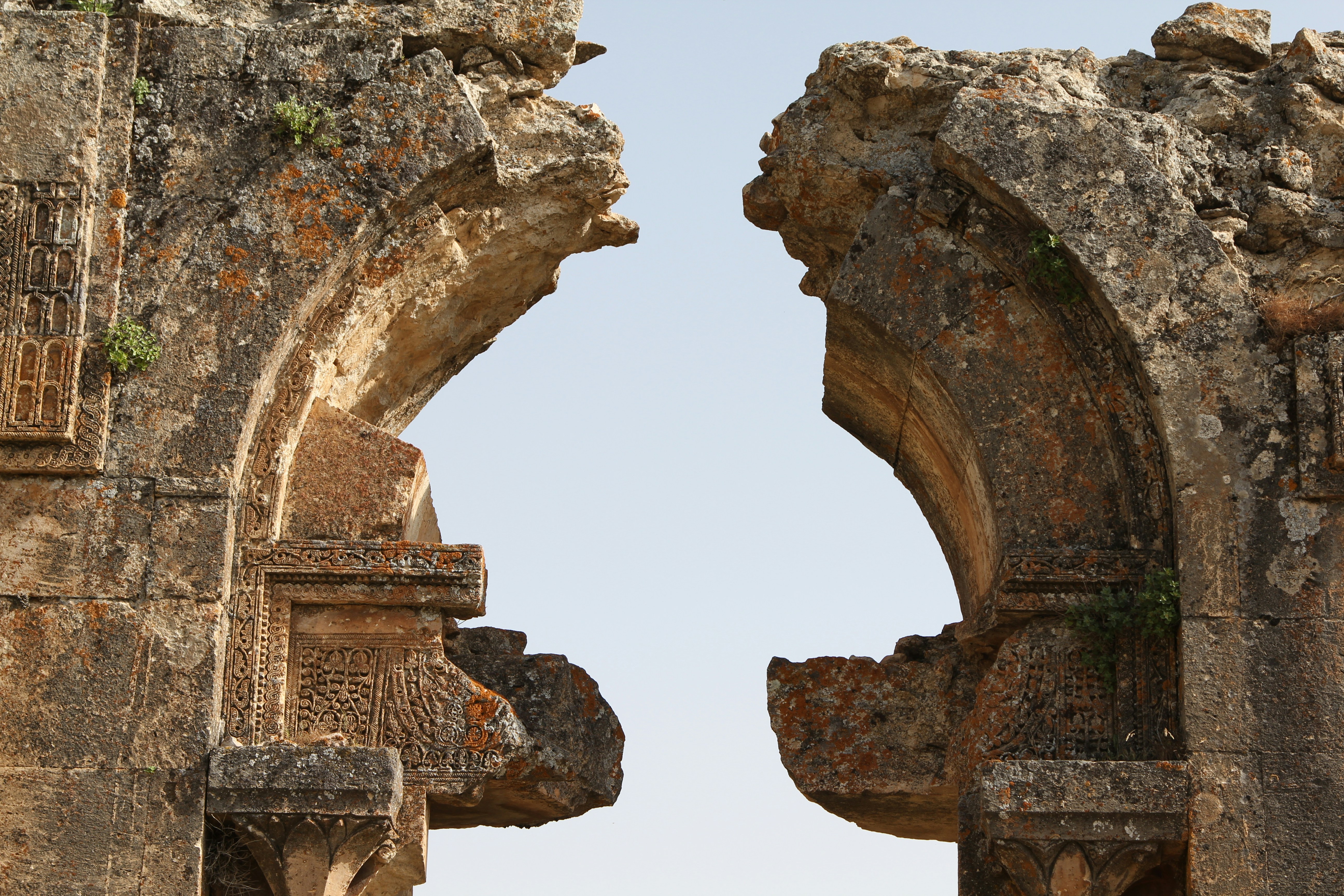 an old stone building with two arched doorways