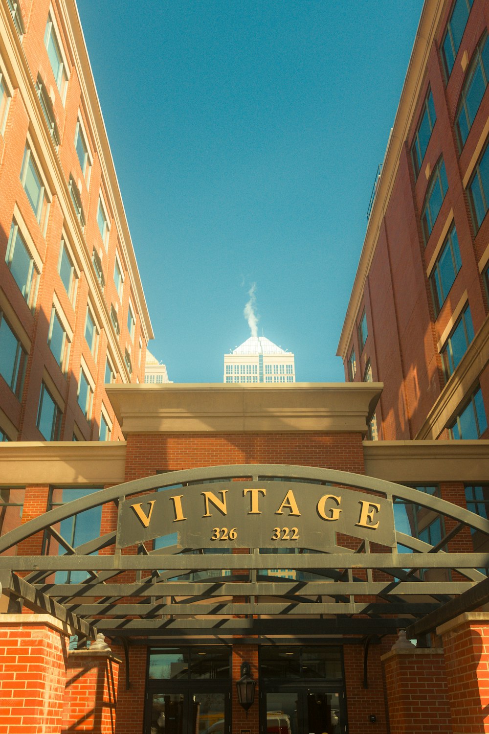 the entrance to a building with a clock tower in the background