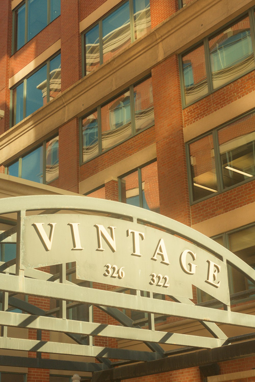 a large brick building with a white sign that reads vintage