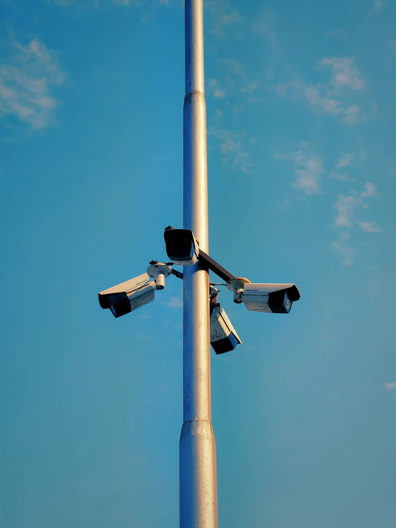 Security cameras on a pole against blue sky