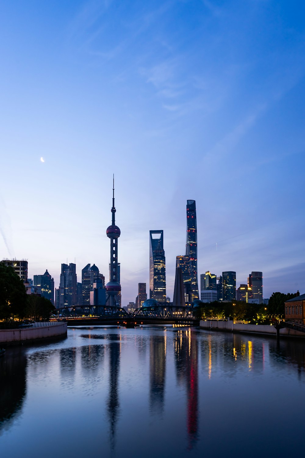 a view of a city at dusk from across a river