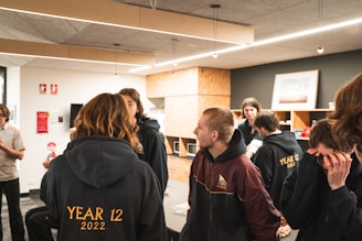 Teenagers studying together in a warm, community-focused yeshiva setting.