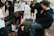 A lively group of people playfully engaging in a safe, energetic playfight session in a cozy Arnhem venue.