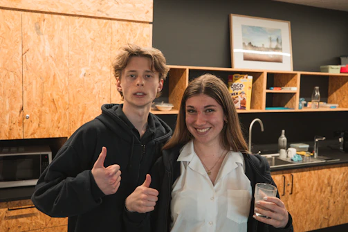 Smiling customer giving a thumbs-up after appliance installation in a Houston kitchen.
