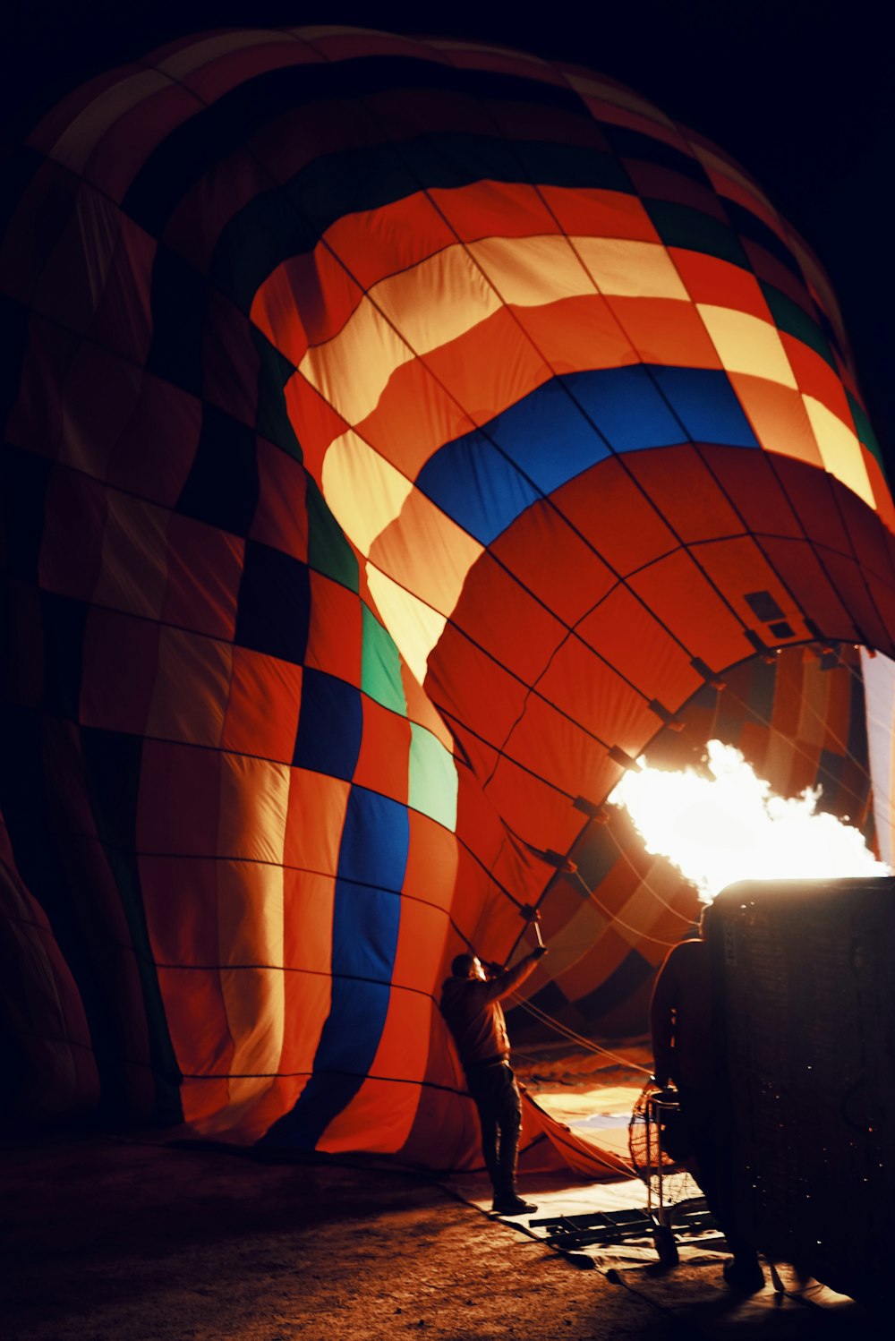 a person standing in front of a large hot air balloon