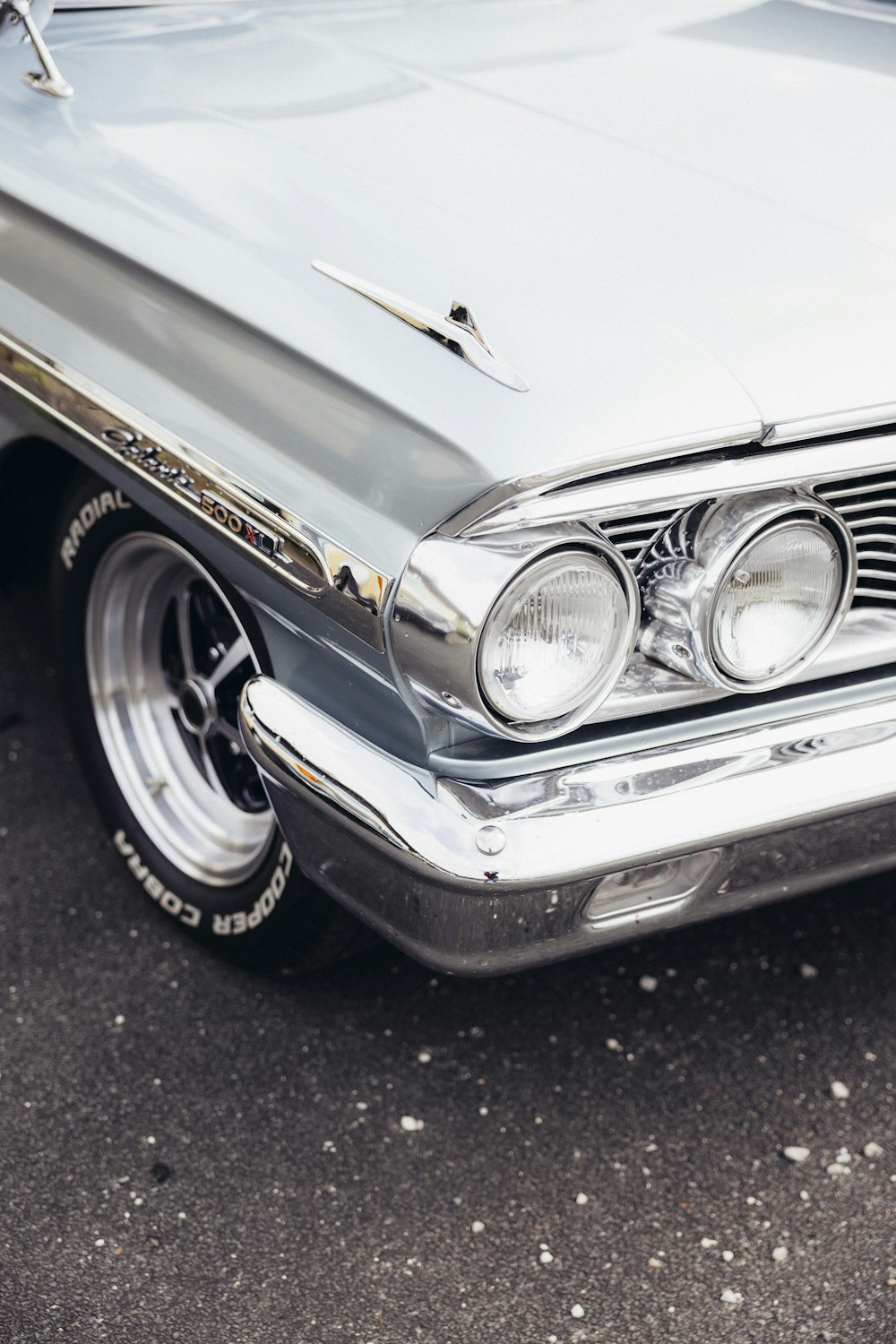 a close up of the front of a classic car