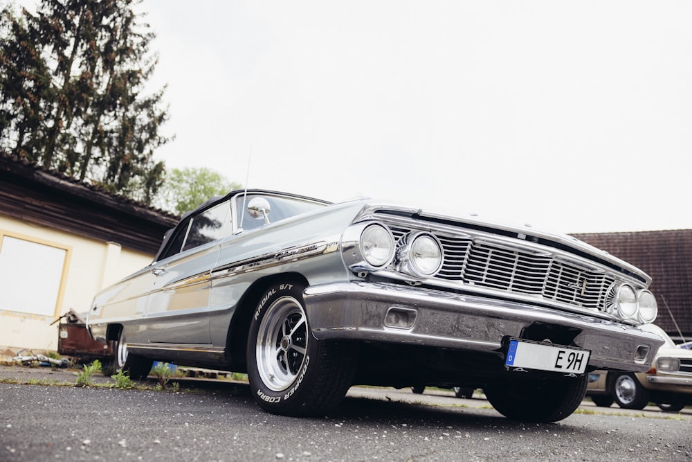 a silver car parked in front of a building