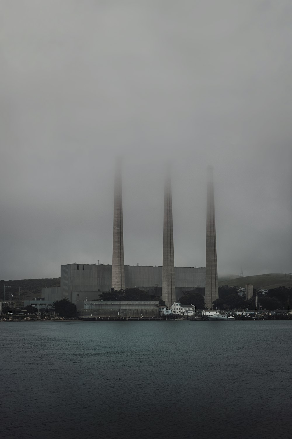 a foggy view of a power plant in the distance