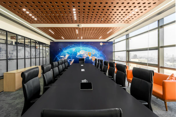 A diverse group of global leaders collaborating in a modern conference room with a world map in the background.