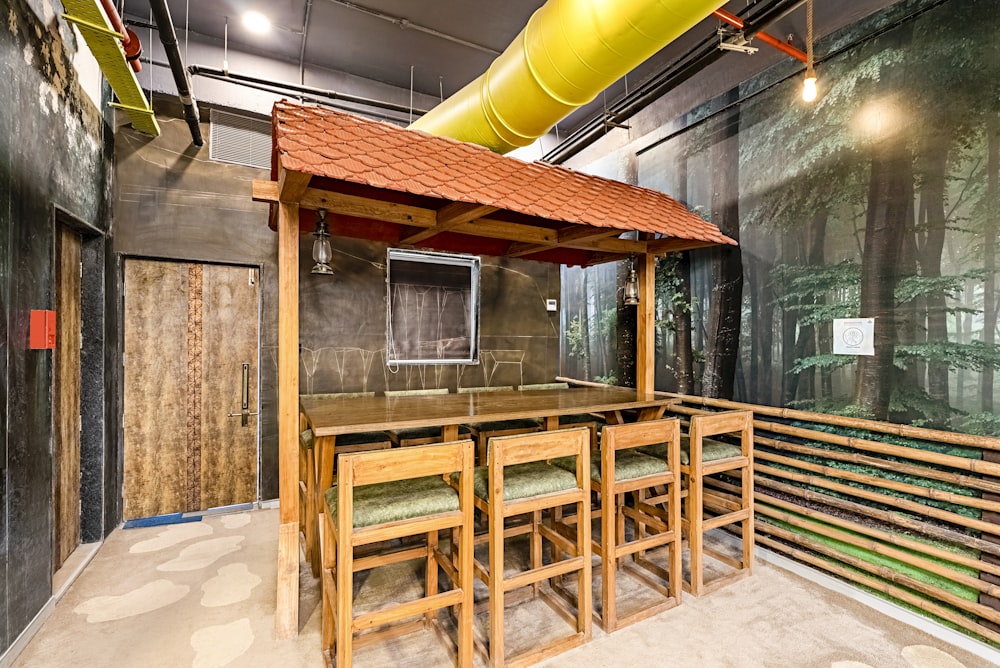 a room that has a wooden table and chairs in it