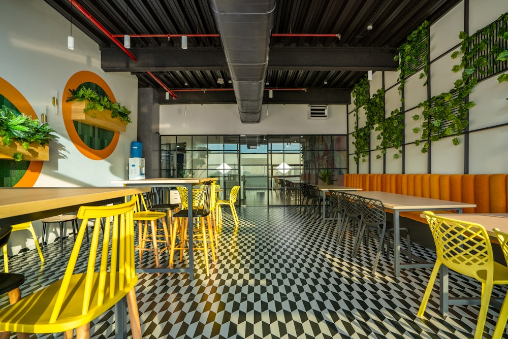 a restaurant with yellow chairs and a checkered floor