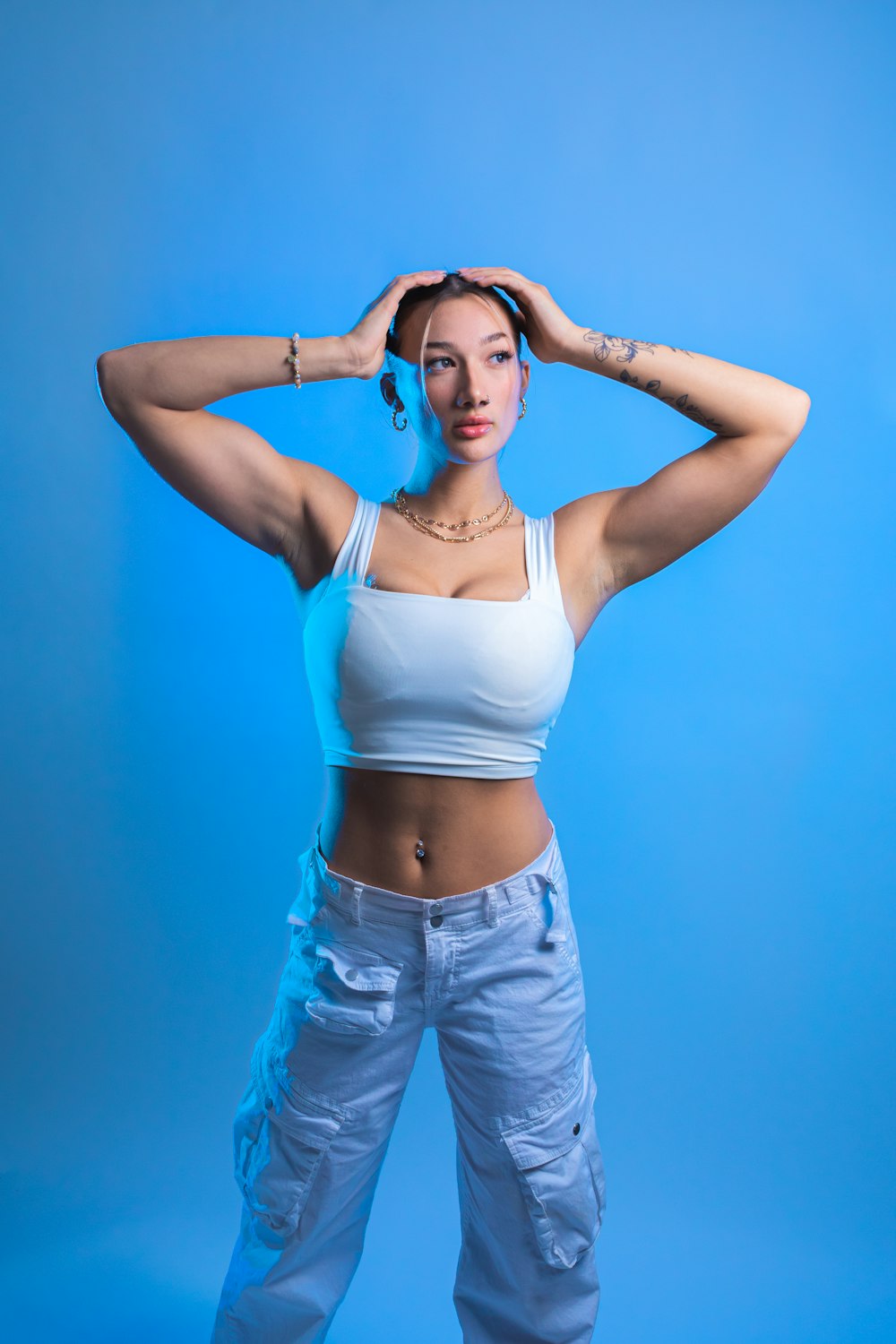 a woman in white top and blue pants posing for a picture