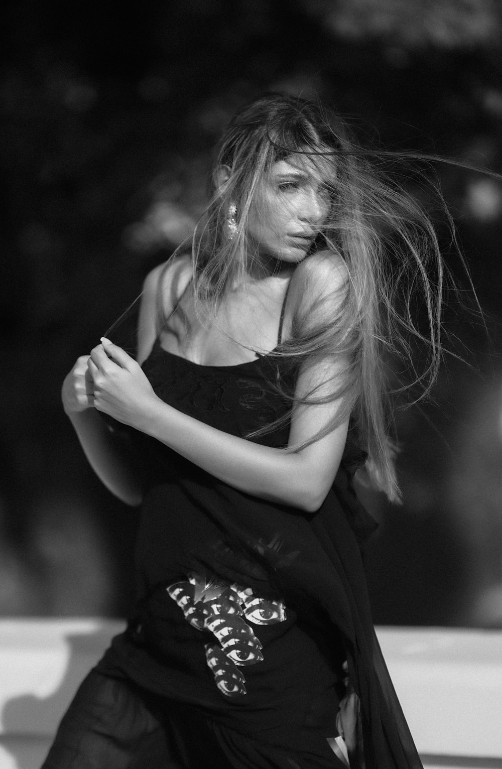 a woman with her hair blowing in the wind