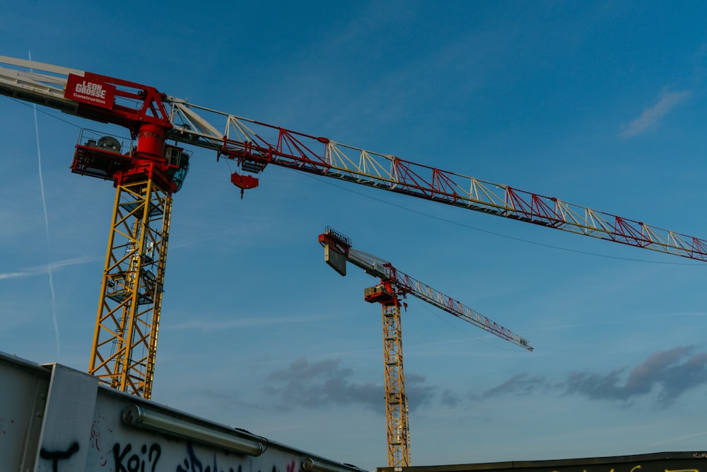 a large crane sitting next to a building under a blue sky