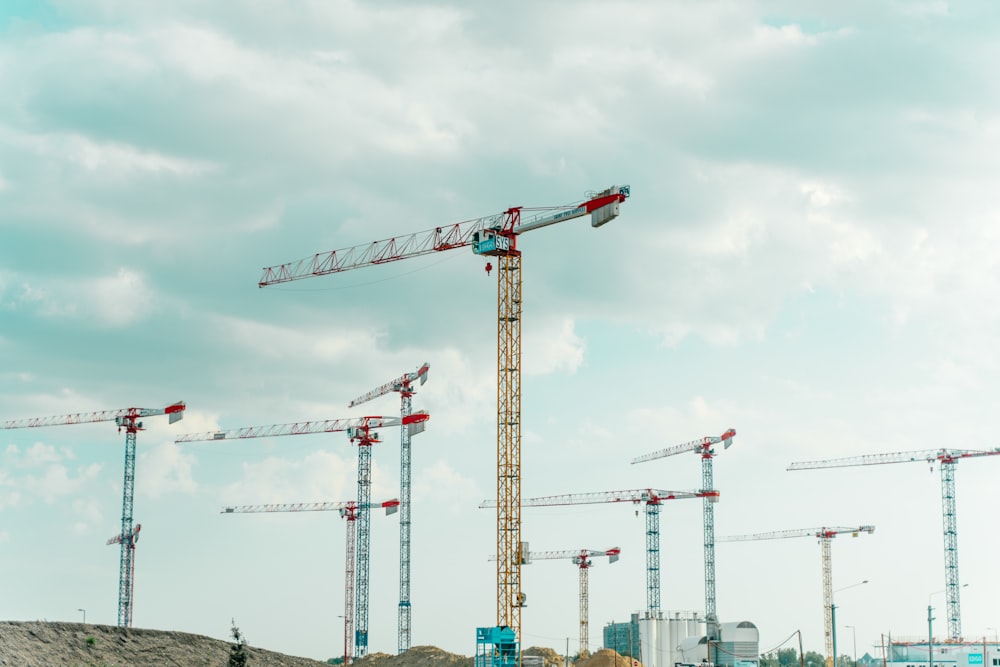 a group of cranes sitting on top of a field