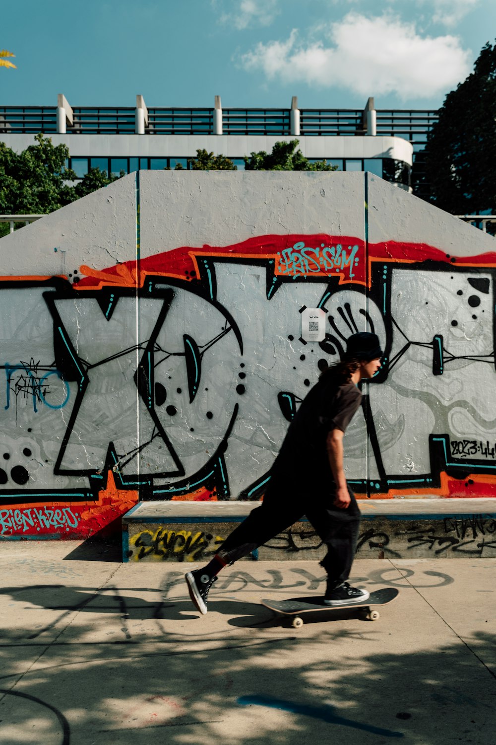 a man riding a skateboard down a sidewalk