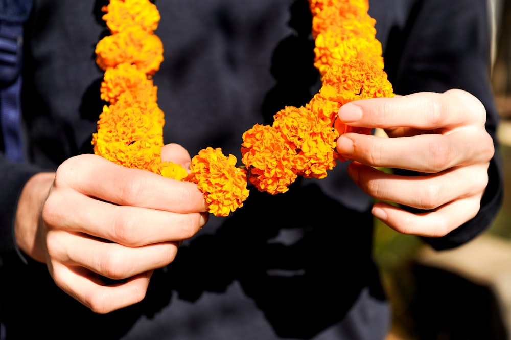 a person holding a bunch of flowers in their hands