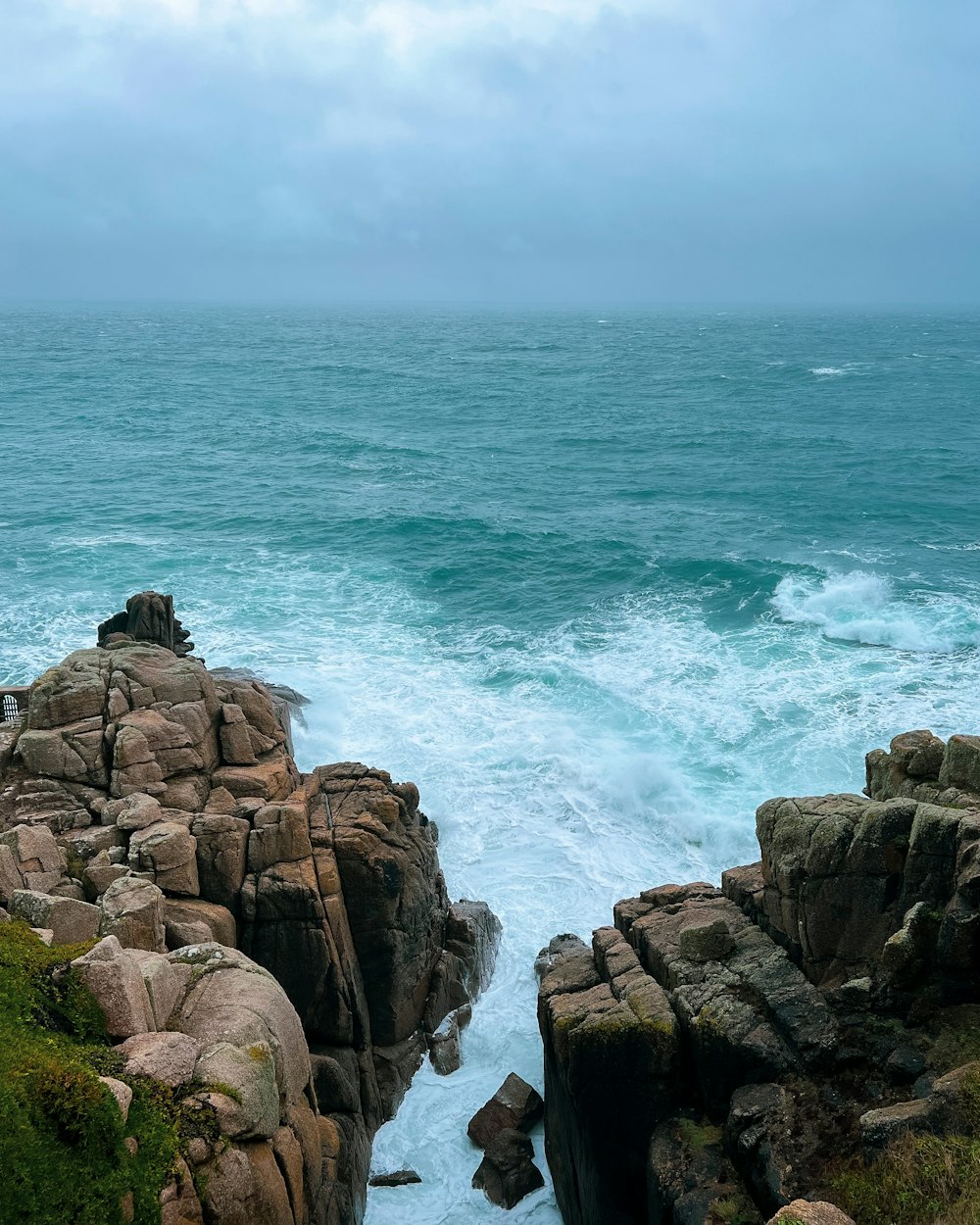 a view of the ocean from a rocky shore