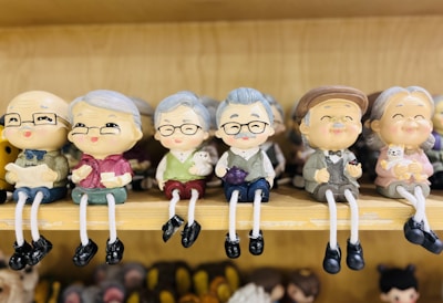 Collection of eccentric figurines displayed on a rustic shelf