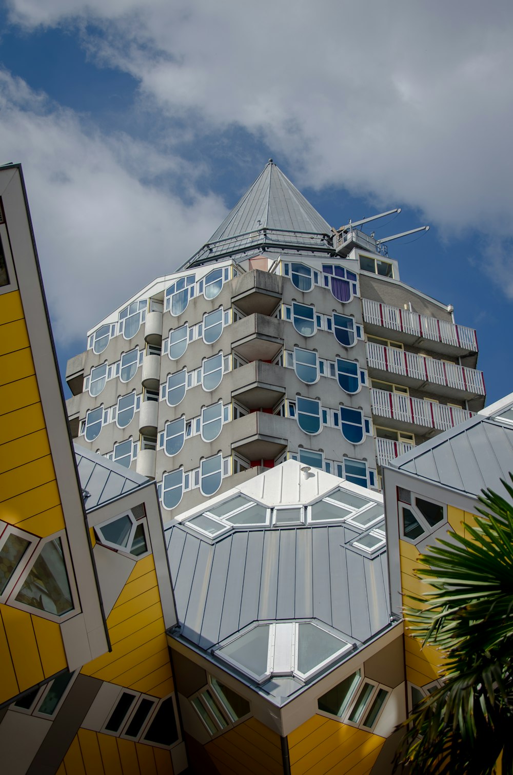 a tall building with many windows and a sky background