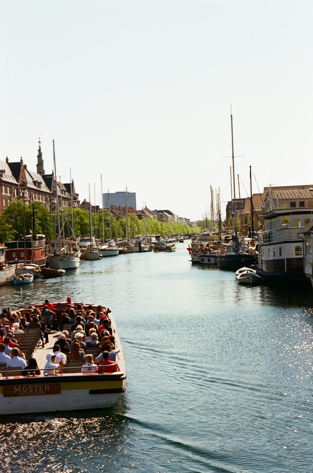 a boat full of people traveling down a river