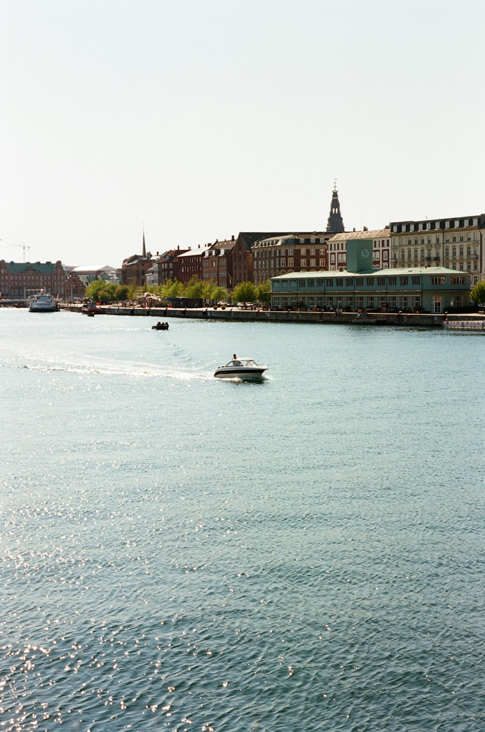 a small boat in the middle of a large body of water