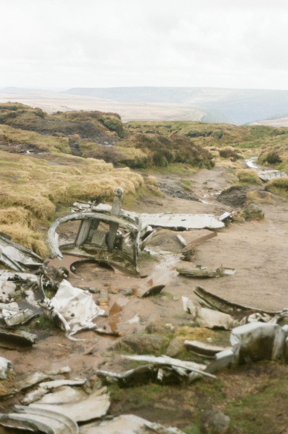 a pile of junk sitting on top of a dirt road