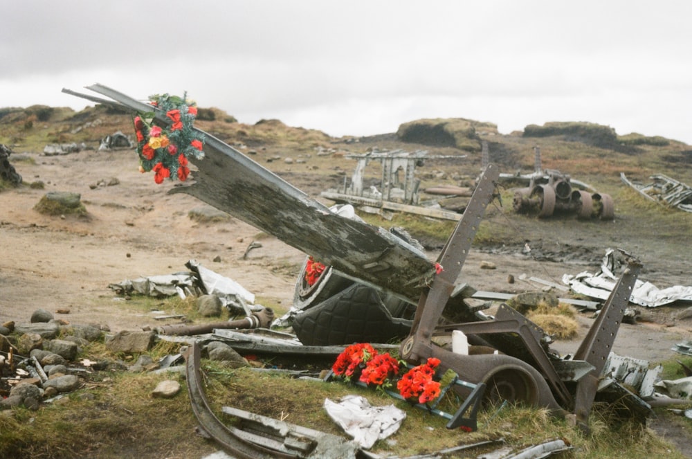 a pile of junk with a bunch of flowers on top of it