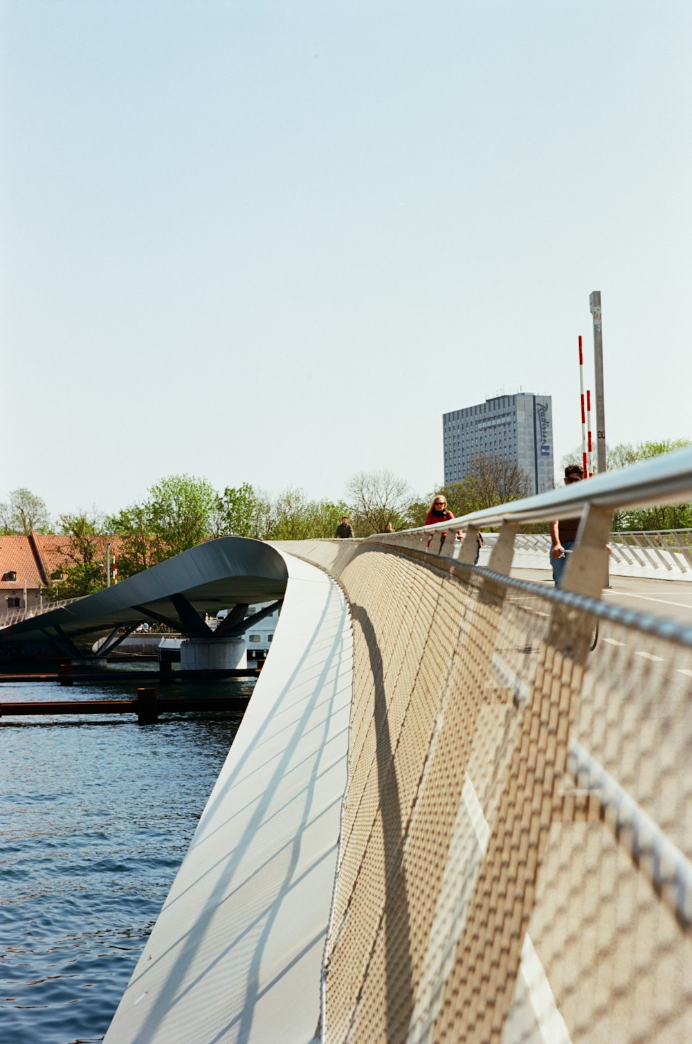 a man riding a skateboard across a bridge